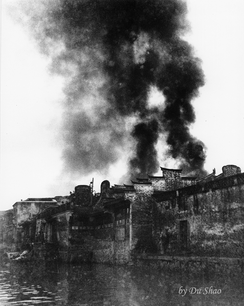 Bombed House Emitting Plumes of Smoke