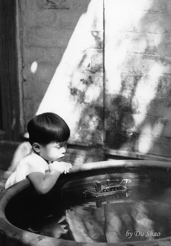 A Kid Playing Model Ship